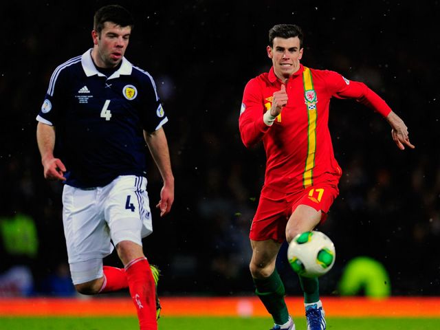 Grant Hanley and Gareth Bale chase the ball.