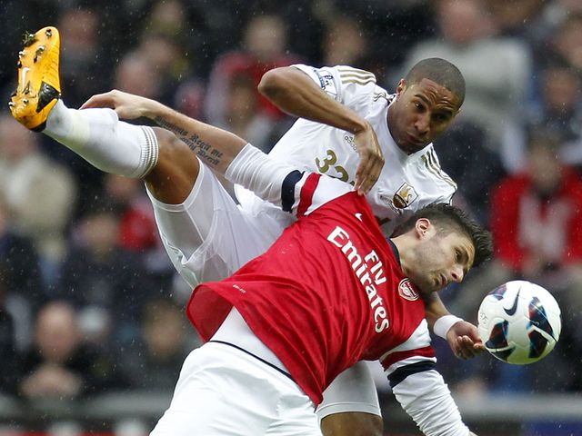 Olivier Giroud vies with Swansea's Ashley Williams