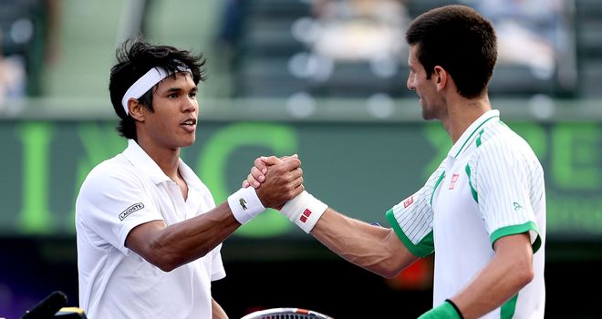 Novak Djokovic (right) shakes hands with Somdev Dewarman