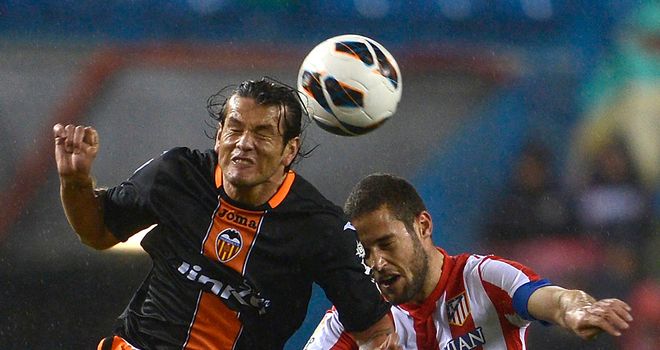 Nelson Valdez and Mario Suarez go up for a header.