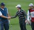 Rory McIlroy shakes hands with Ernie Els before quitting the Honda Classic