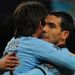 Tevez gets a hug from David Silva after making it 3-0