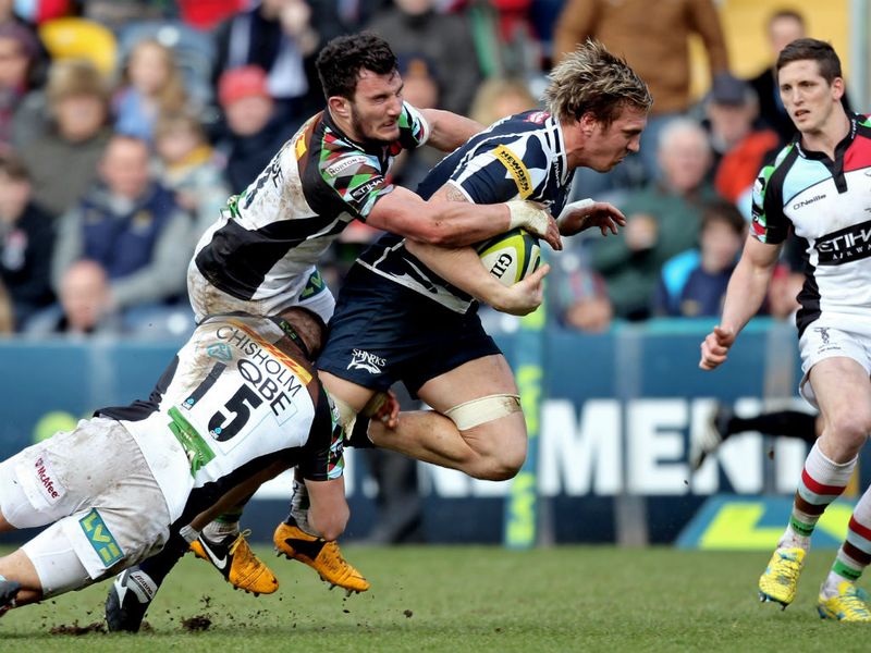 Hard battle: Andy Powell of Sale Sharks is hauled down by Ross Chisholm and George Lowe of Harlequins