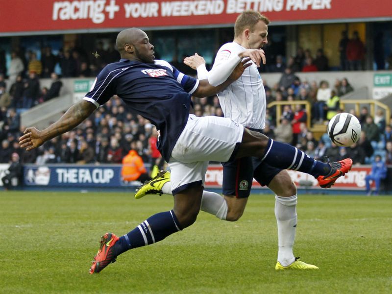 Millwall defender Danny Shittu tackles Blackburn striker Jordan Rhodes at The Den