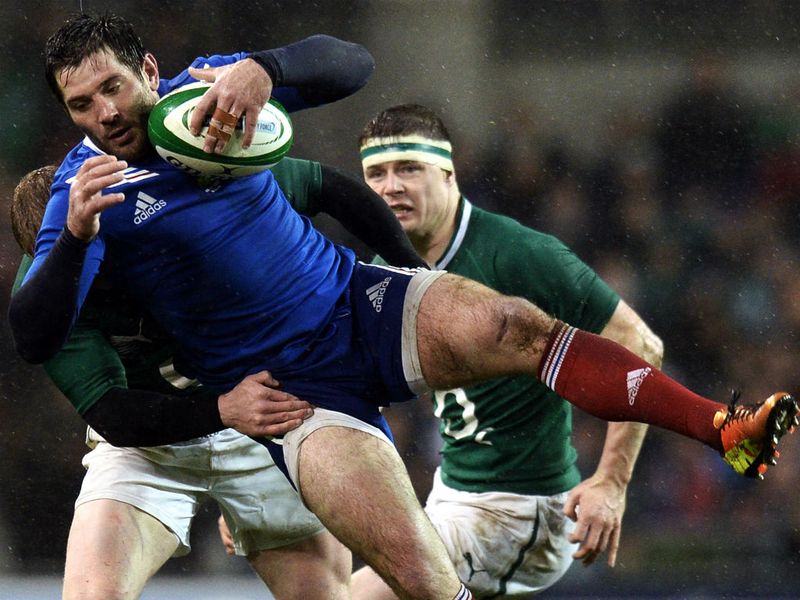 Brought down: France's centre Florian Fritz is tackled by Luke Marshall
