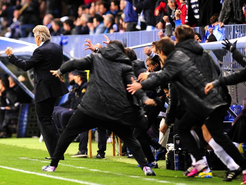 The Malaga bench celebrates following Isco's goal which made it 1-1 on aggregate against Porto