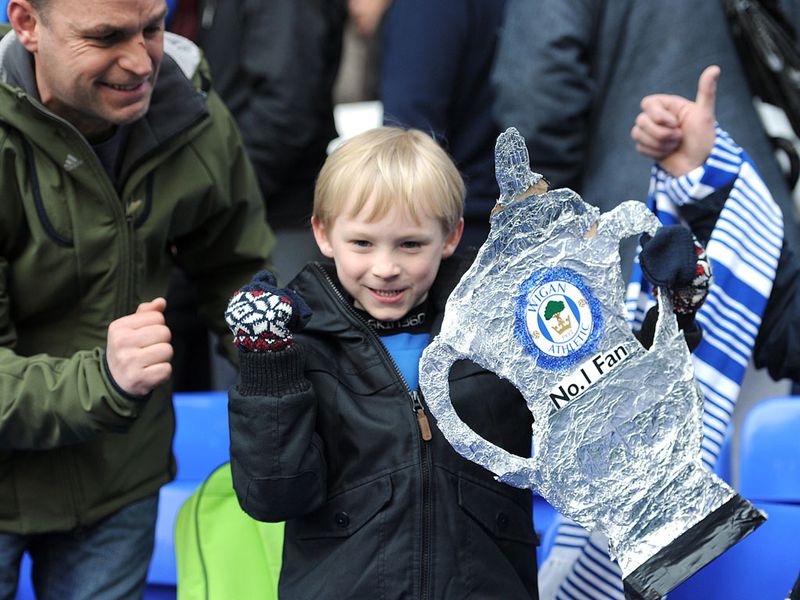 This Wigan fan is all smiles as a 3-0 win takes the Latics into the semi-finals