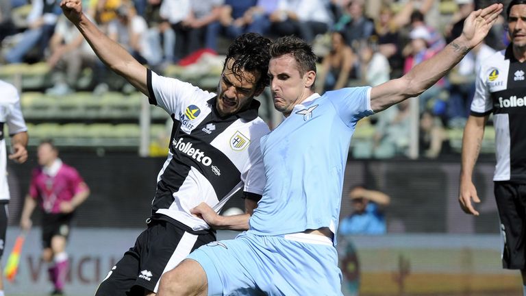 Marco Parolo and Miroslav Klose slide in for the ball