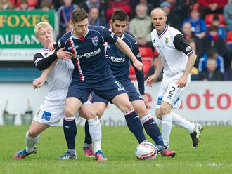 Iain Vigurs keeps possession.