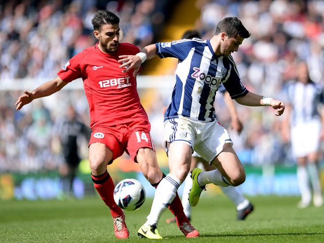 Jordi Gomez and Shane Long in action.