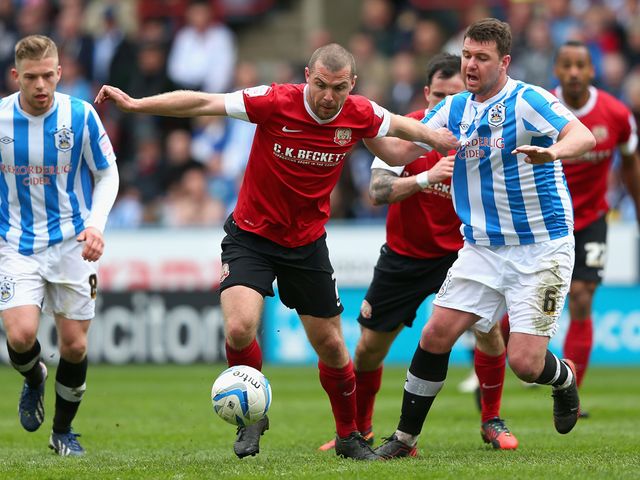 Stephen Dawson and Anthony Gerrard battle for the ball.