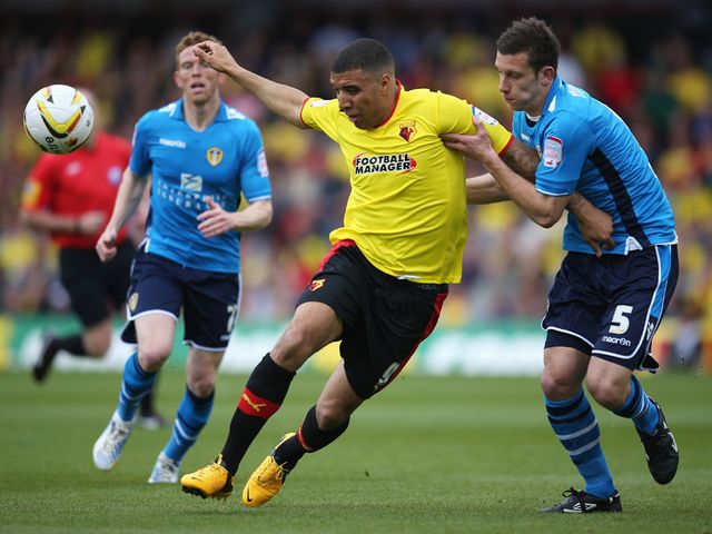 Troy Deeney is challenged by Jason Pearce.