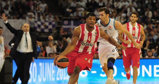 Olympiacos' Kyle Hines dribbles away from Rudy Fernandez of Real Madrid