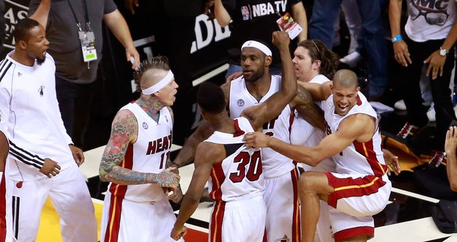 LeBron James (centre) celebrates with team-mates after the buzzer