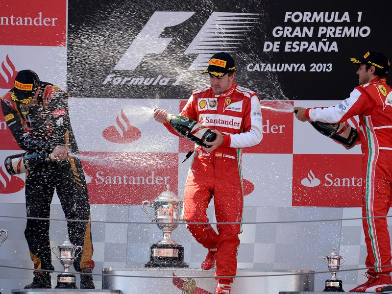 Kimi Raikkonen, Fernando Alonso and Felipe Massa celebrate on the podium