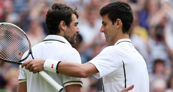 Novak Djokovic (r) and Jeremy Chardy shake hands at the end of their one-sided match on Centre Court