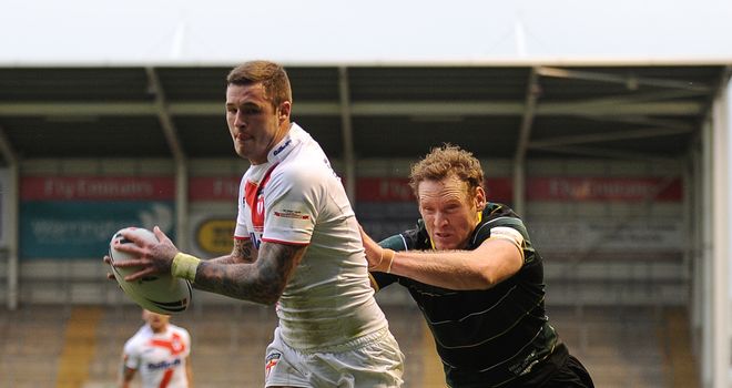 Too strong: Exile's Joel Monaghan fails to stop England's Zak Hardaker from scoring the opening try at the Halliwell Jones Stadium