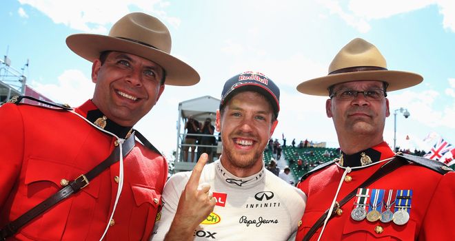 Sebastian Vettel: Celebrates his GP win with two Canadian Mounties