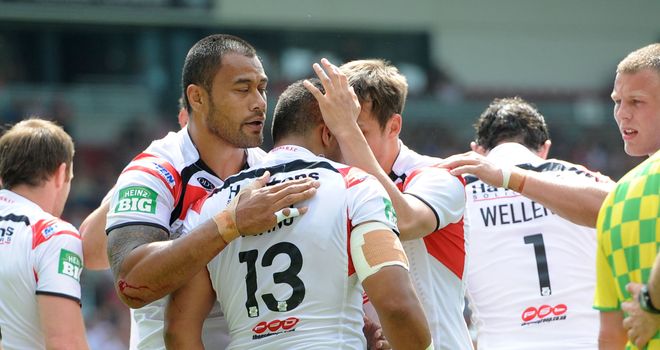 Willie Manu is congratulated by St Helens team-mates after scoring his try