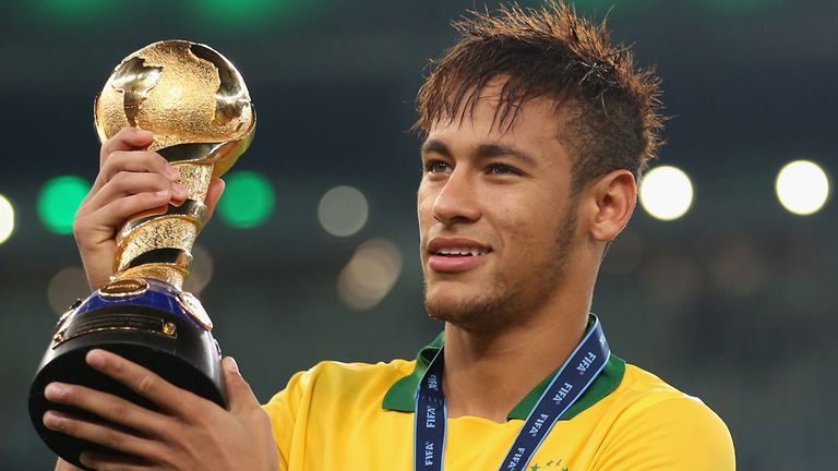 Neymar: Celebrates with the trophy after Brazil beat Spain 3-0