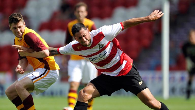 Iain Vigurs: Battles Doncaster's Billy Paynter for the ball