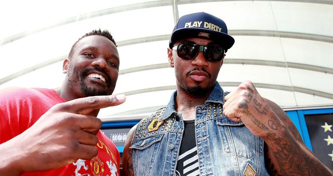 Dereck Chisora (L) and Malik Scott collide at Wembley on Saturday
