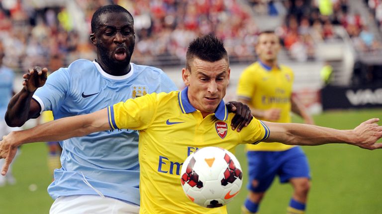 Laurent Koscielny shields the ball from Yaya Toure in Helsinki