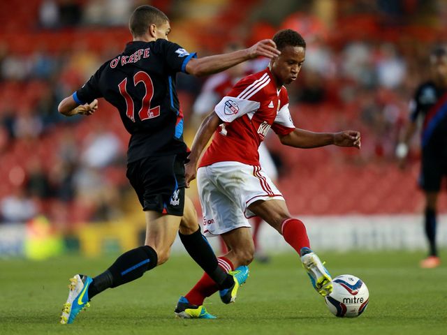 Bobby Reid and Stuart O'Keefe fight for possession