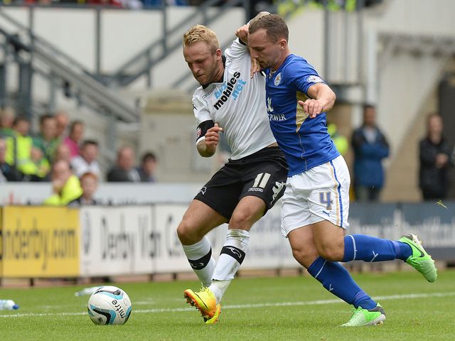 Johnny Russell and Danny Drinkwater battle for the ball