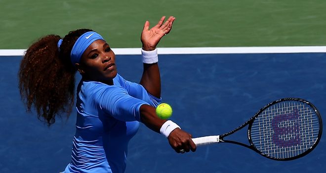 Serena Williams returns a shot to Eugenie Bouchard of Canada during the Western & Southern Open