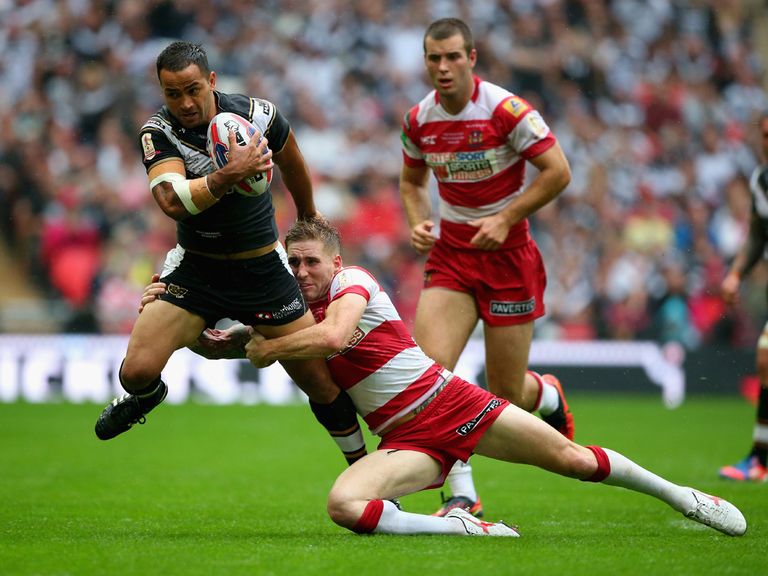 Sam Tomkins attempts to hold up Aaron Heremaia
