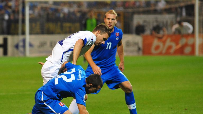 Bosnia's Edin Dzeko gets in a tangle