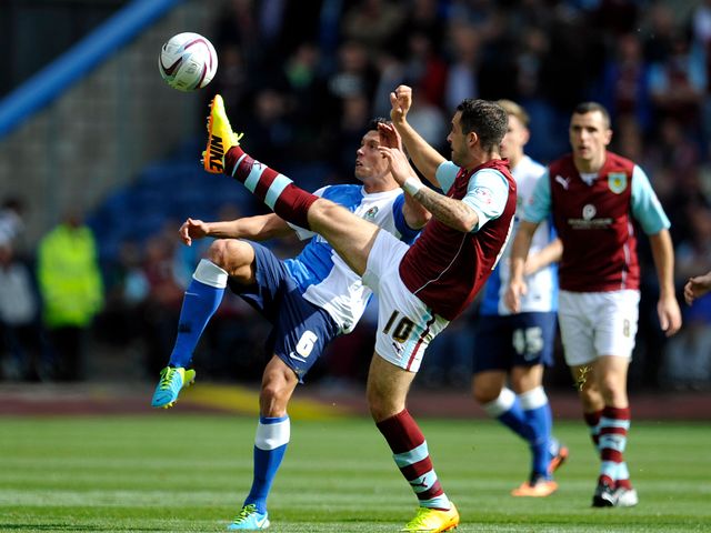 Jason Lowe and Danny Ings battle for the ball