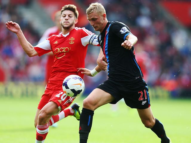 Dean Moxey holds off Adam Lallana