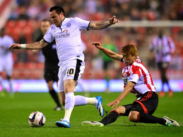 Lee Tomlin tries to find space.