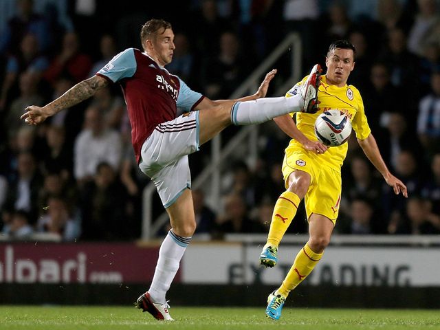 Jack Collison challenges Don Cowie.