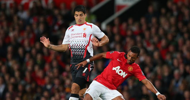 Luis Suarez: Is tackled by Nani on his Liverpool comeback