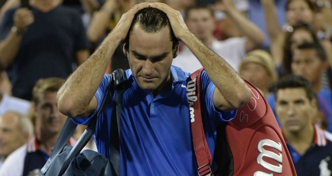 Roger Federer is left dejected by his US Open loss to Tommy Robredo