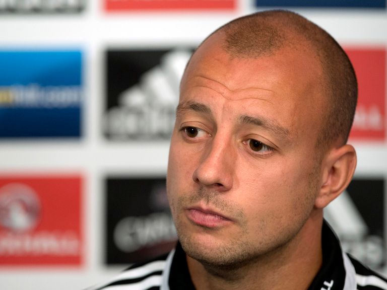 Alan Hutton faces the press.