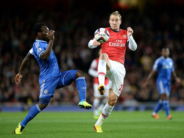 Essien and Bendtner battle for the ball