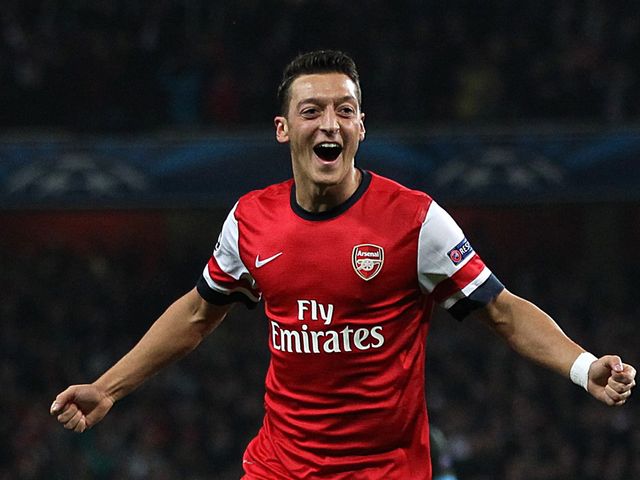 Mesut Ozil celebrates his goal for Arsenal against Napoli
