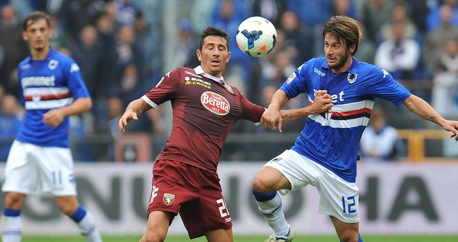 Giuseppe Vives and Gianluca Sansone battle for the ball