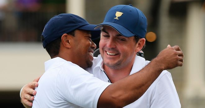Tiger Woods is hugged by Keegan Bradley after claiming the winning point