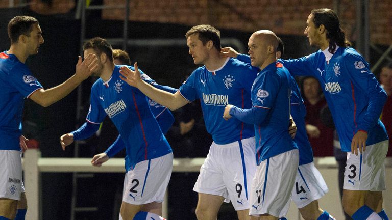 Jon Daly: Gets congratulations from his Rangers team-mates after opening scoring at Arbroath