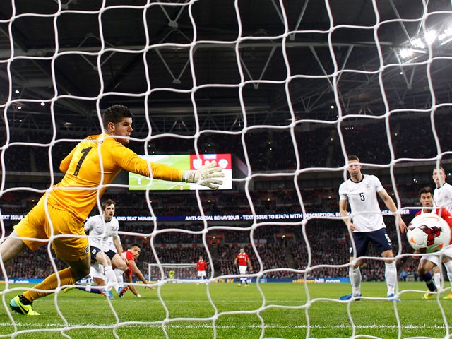 Alexis Sanchez heads the opening goal of the game at Wembley