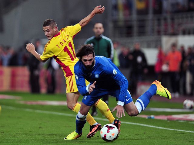 Gabriel Torje and Giorgos Samaras battle for the ball