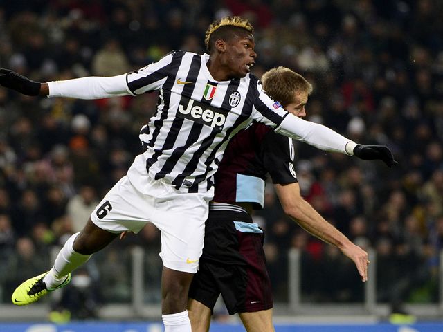 Paul Pogba and Lars Jacobsen battle for the ball