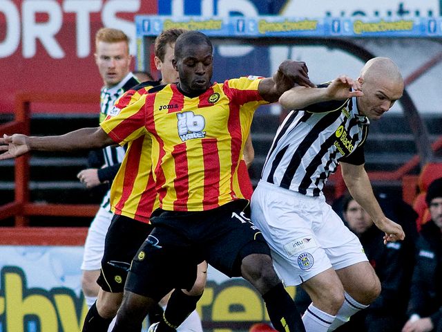 Isaac Osbourne (left) battles for the ball with Jim Goodwin