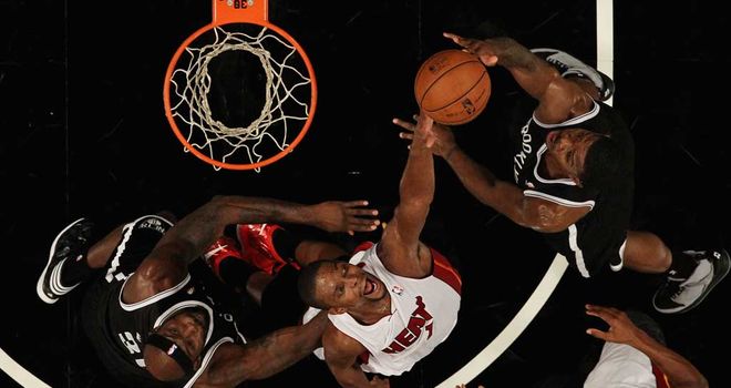 Chris Bosh goes for a block in Miami's narrow defeat by Brooklyn