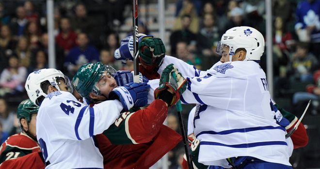Nazem Kadri and Mark Fraser clash with Nino Niederreiter of the Minnesota Wild